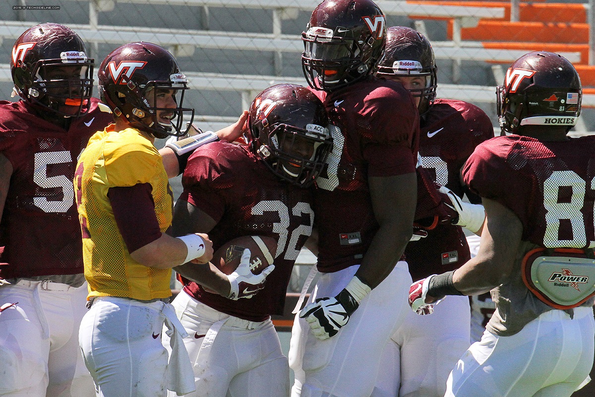 The offense celebrates a Steven Peoples touchdown.